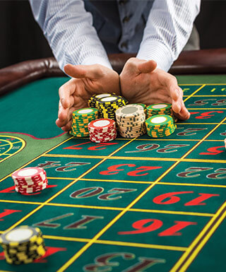Roulette player bidding all in at table