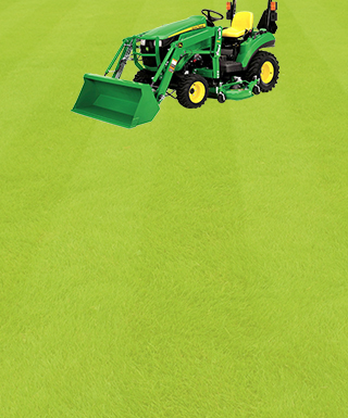 John Deer tractor on a grassy lawn with lines in it.
