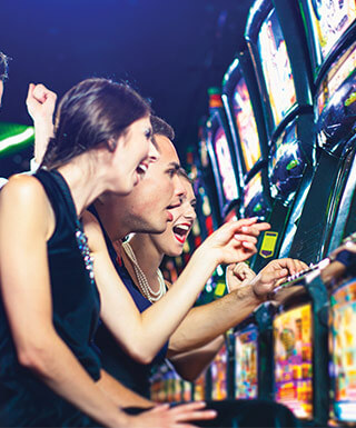 Friends cheering at the slots together