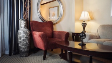 large chair and table in living area in suite
