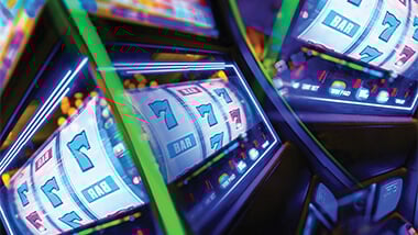 Glowing slot machine on all sevens