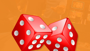 close up of pair of red dice on orange background