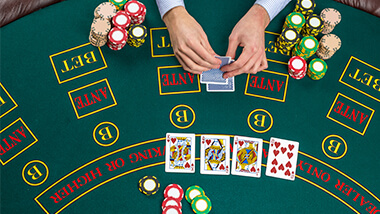 Guest playing poker with chips around them.