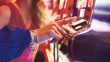 woman pushing slot button